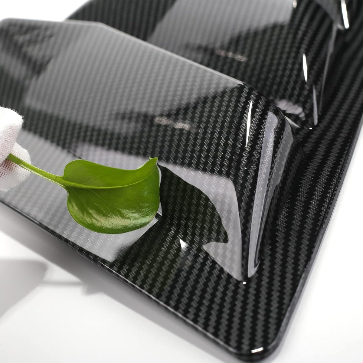 Close-up of carbon fiber Toyota Camry louvers showing glossy ABS finish and eco-friendly surface.