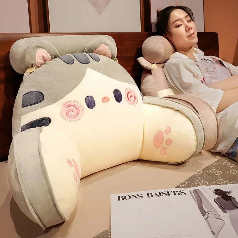Large cartoon cat backrest pillow in use on a bed, providing lumbar support and enhancing bedroom comfort and decor.
