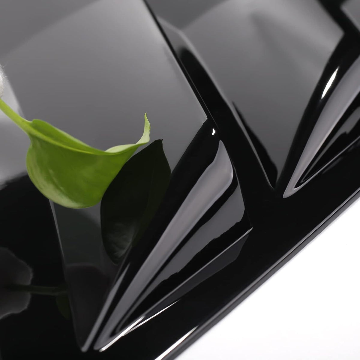 Close-up of gloss black Toyota Camry louvers with smooth ABS surface and eco-friendly design.