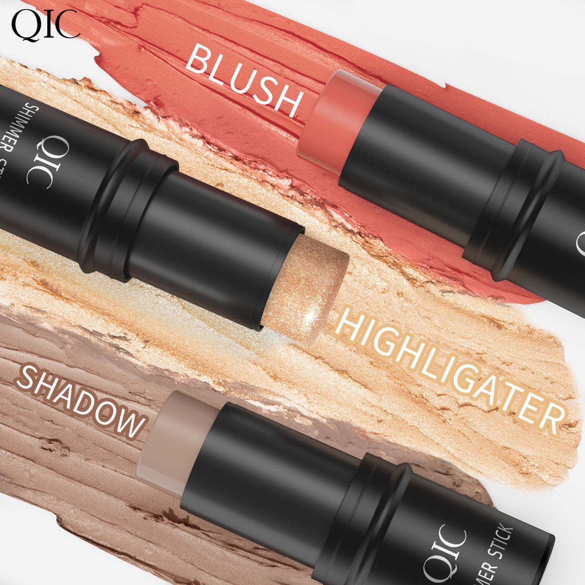 Flat lay of QIC shimmer sticks labeled blush, highlighter, and shadow. Creamy textures for easy blending and radiant finish.