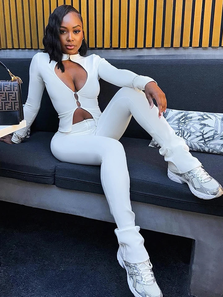 White stylish 2-piece tracksuit set with zip-up front and thumbhole sleeves, combining comfort and bold fashion for women.