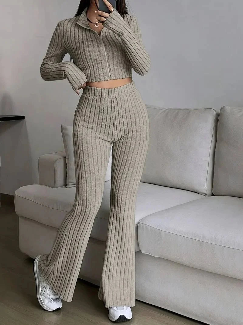 Beige ribbed striped 2-piece women's outfit with a fitted crop top and high-waisted flared pants. Great for relaxed, stylish looks.