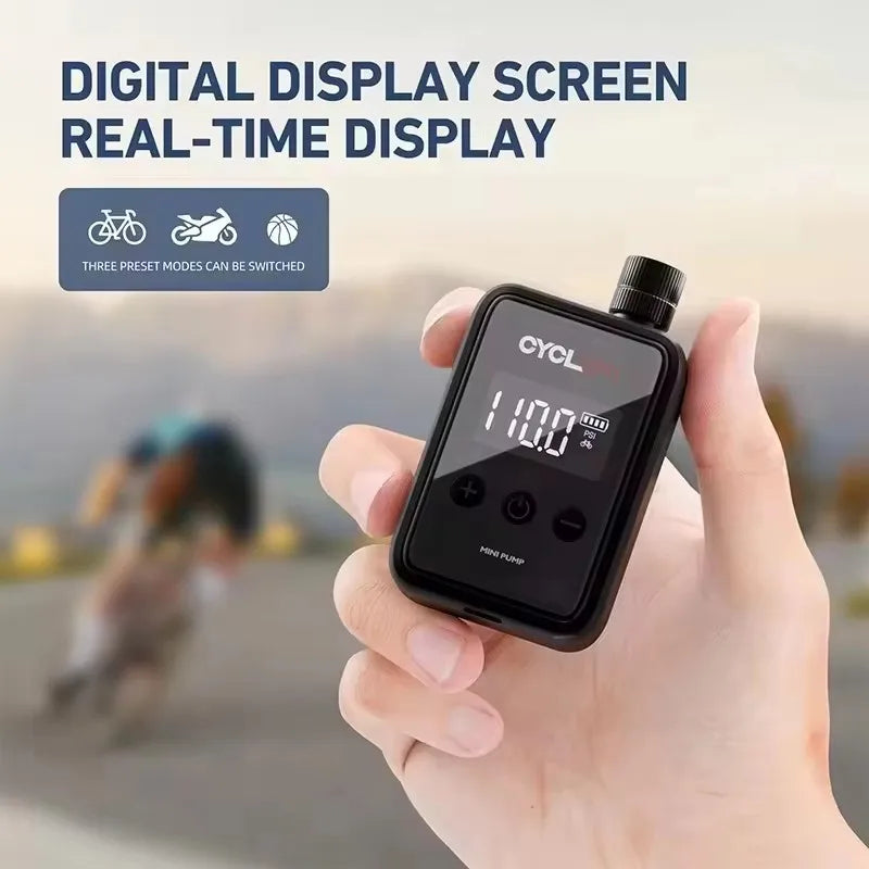 Portable Electric Bike Pump 150Psi with digital display screen in hand. Mini inflator shows real-time pressure for bikes, balls, and more.