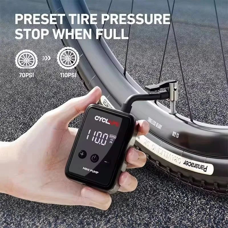 Mini High-Pressure Inflator preset to 110Psi inflating a bicycle tire. Portable electric pump stops automatically when full.