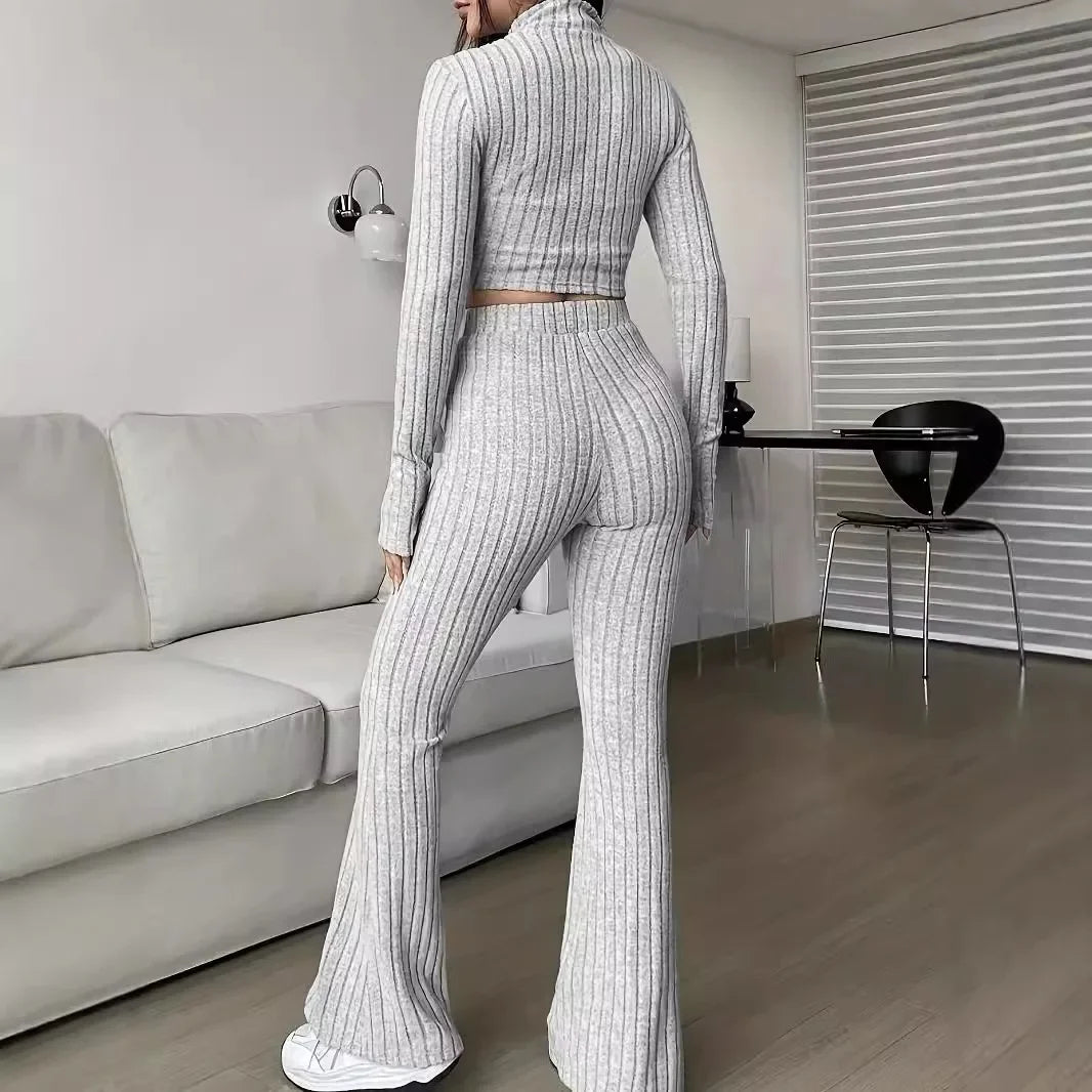 Back view of gray striped 2-piece women's set showing ribbed crop top and flared pants. Highlights the flattering fit and cozy design.