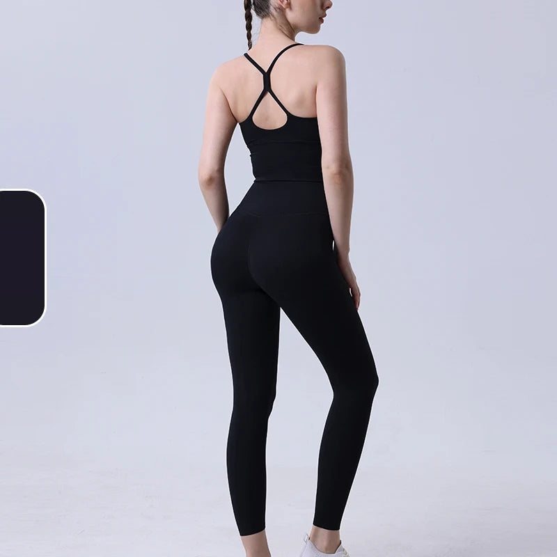 Black 2-piece yoga tracksuit for women with supportive bra and high-rise leggings, suitable for fitness and casual wear.