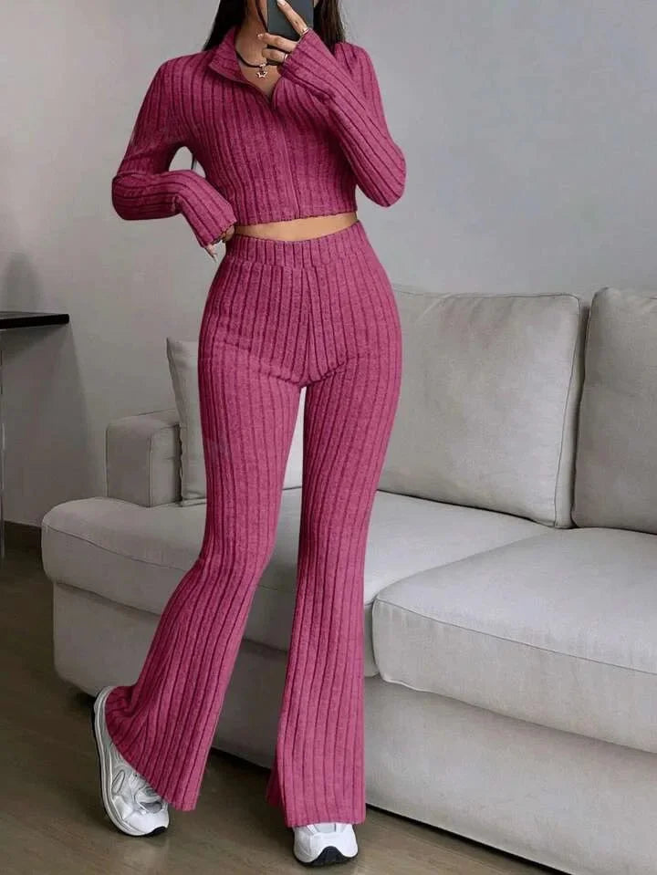Pink ribbed striped 2-piece women's set with long sleeves and flared pants. Combines comfort and flair for casual everyday wear.