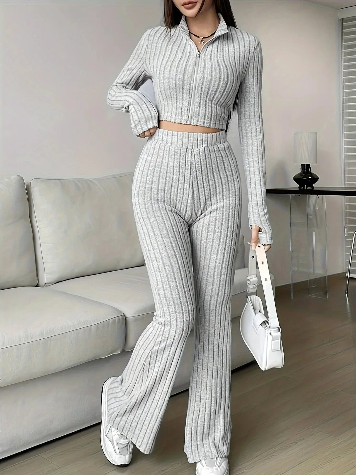 Light gray striped 2-piece women's set with zip-up crop top and flared pants. A chic and cozy choice for casual fashion lovers.