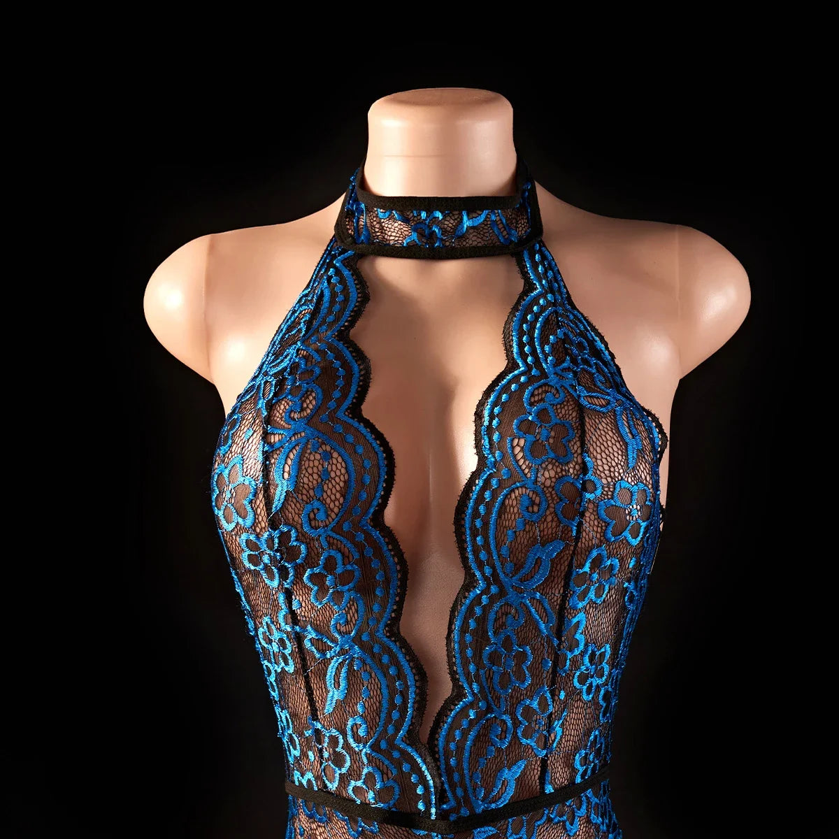 Close-up of blue lace bodysuit's plunging neckline and floral embroidery, showcasing sexy V-neck lingerie for women.