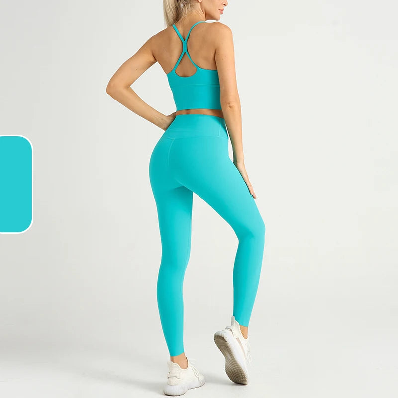 Turquoise yoga tracksuit set for women including a crop sports bra and leggings, crafted for comfort and flexibility.