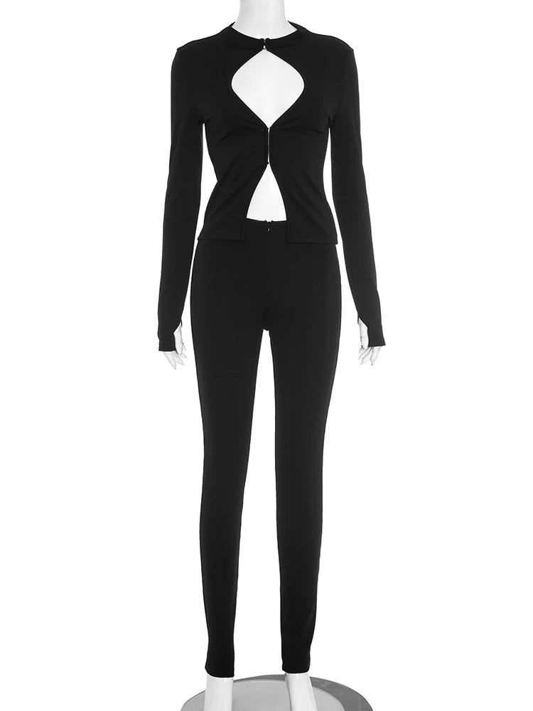 Black sexy tracksuit set displayed on mannequin, featuring a zip-up cut-out top and fitted pants for women's stylish outfit sets.