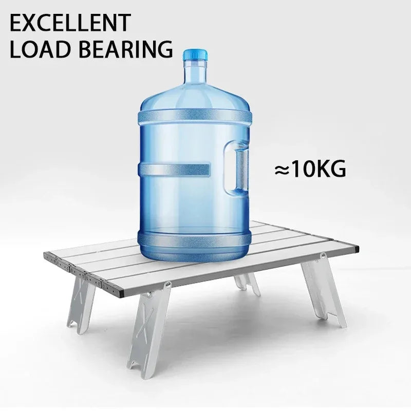 Aluminum Folding Camping Table supporting 10kg water jug. Ultralight travel desk with excellent load-bearing capacity.