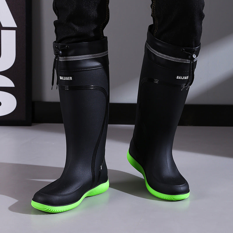 Black Men's Rain Boots with green anti-slip soles, high tube style for outdoor sports and wet weather protection.